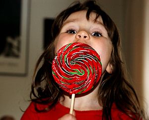 a girl with a lollipop