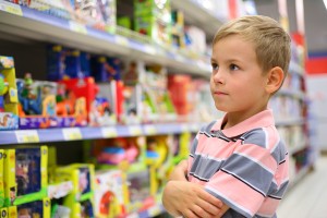 bigstock-boy-looks-at-shelves-with-toys-4347033-300x200